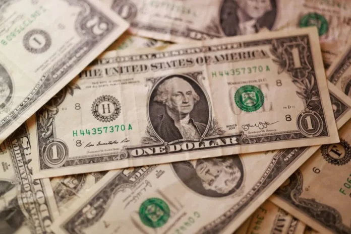 Dollar eases from 13-month high after data burst
